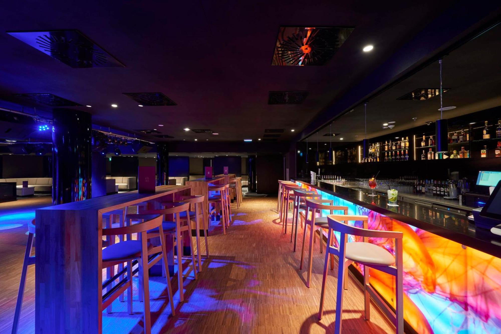 Radisson Blu Resort ชวีโนวิชแจ ภายนอก รูปภาพ The photo depicts a modern bar interior with a sleek and contemporary design. There are high wooden stools positioned along a bar counter, which features vibrant, colorful lighting underneath. The bar area is dimly lit, creating a nightlife ambiance,